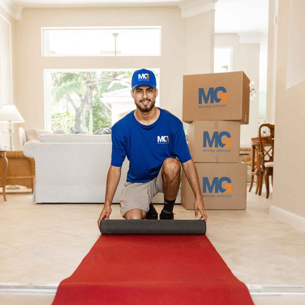 MG Moving employee laying red carpet