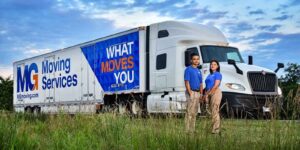 MG Moving employees in front of moving truck