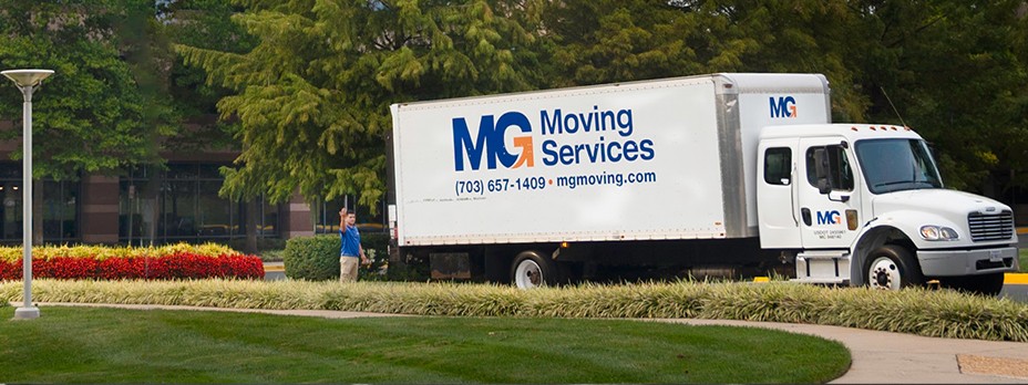 MG Moving employees in front of moving truck