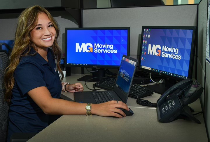 MG Moving Services employee working on moving checklist for customer